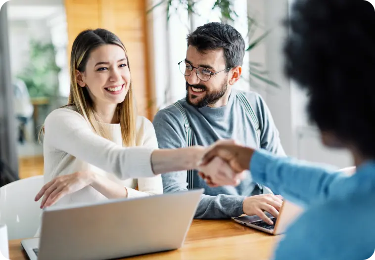 Happy home sellers shaking hands with Agent